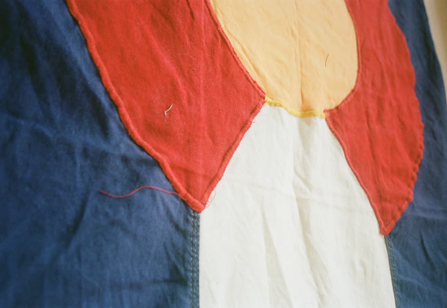 A close-up of the Colorado state flag in the Denver office