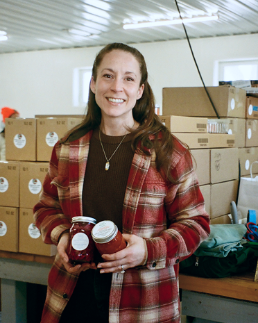 Kimberly, a food processing business owner, standing in her warehouse — 100% increase in sales