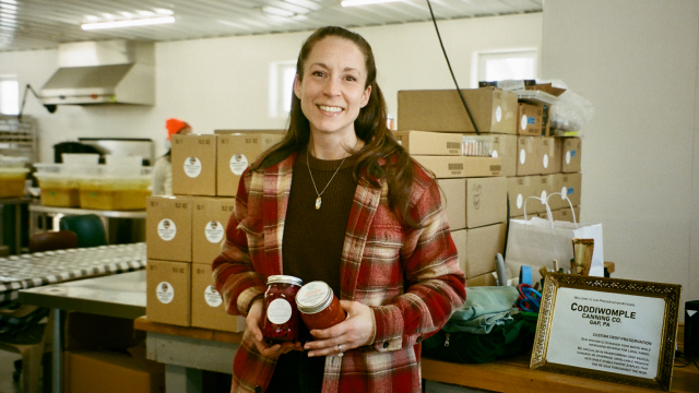 Kimberly, a food processing business owner, standing in her warehouse — 100% increase in sales