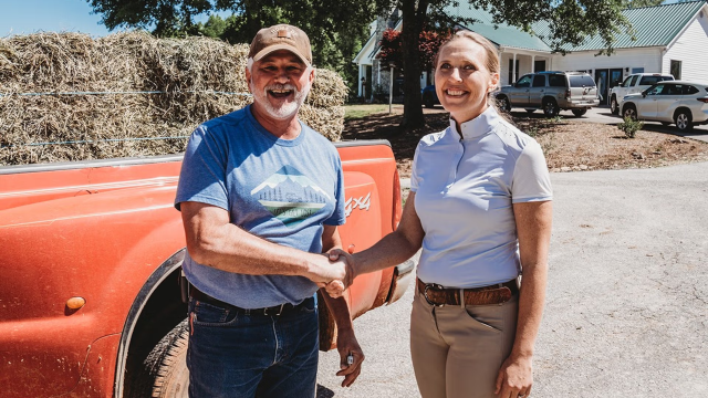 Nicole Miller, a farm nutrition business owner, standing on her farm