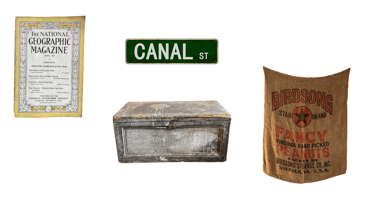 Office ephemera: a National Geographic, a Canal St sign, a weathered chest, and a Birdsong peanuts sack