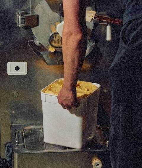 Food processing employee moving ingredients within a plant